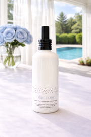 Blue Rose Penn State Themed Linen Spray on a white table with blue roses and a pool in the background