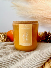 NITTANY CANDLE COMPANY wood wick candle with a cork lid on a textured surface with decorative elements