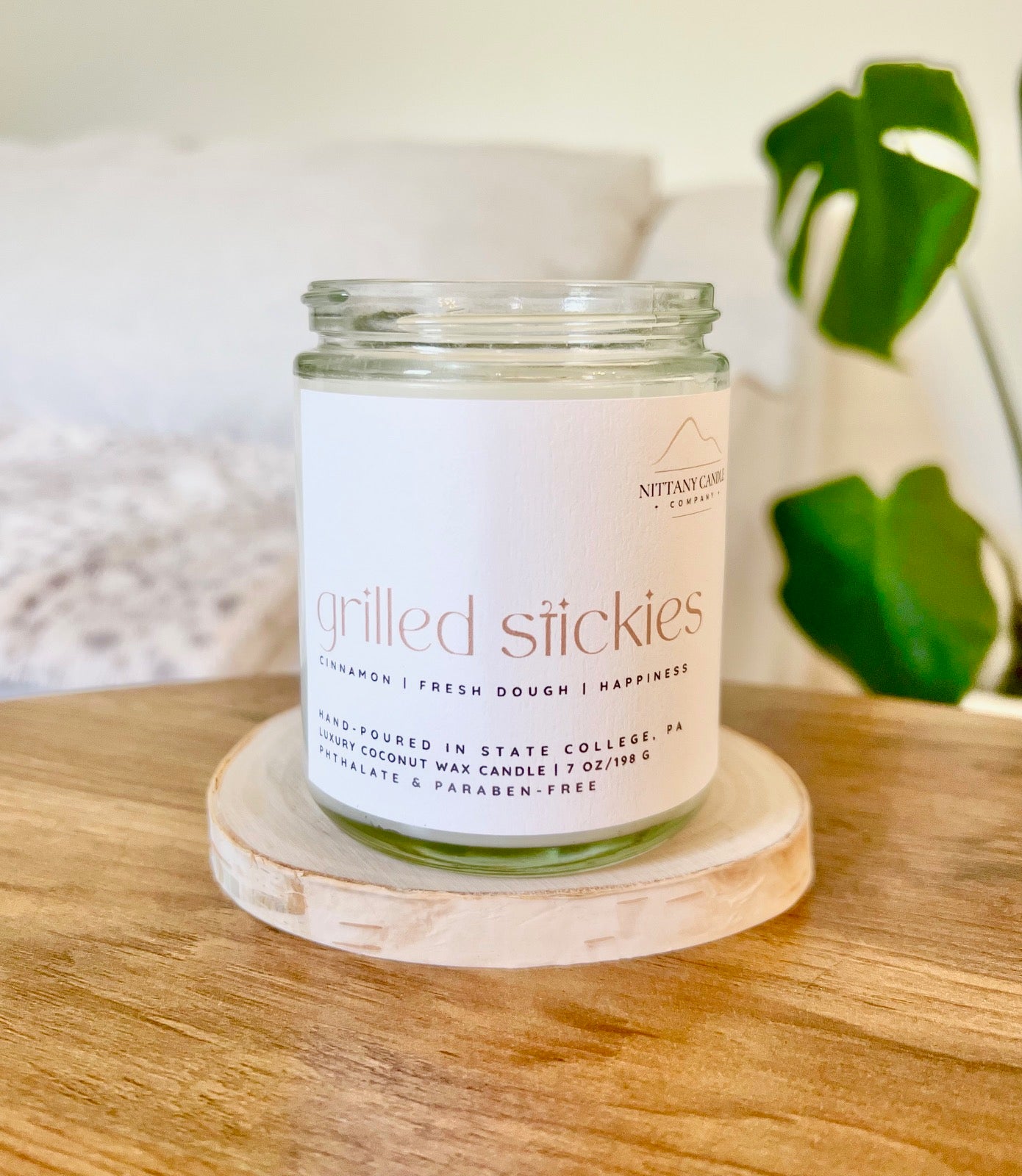 Coconut wax jar candle labeled "grilled stickies"
