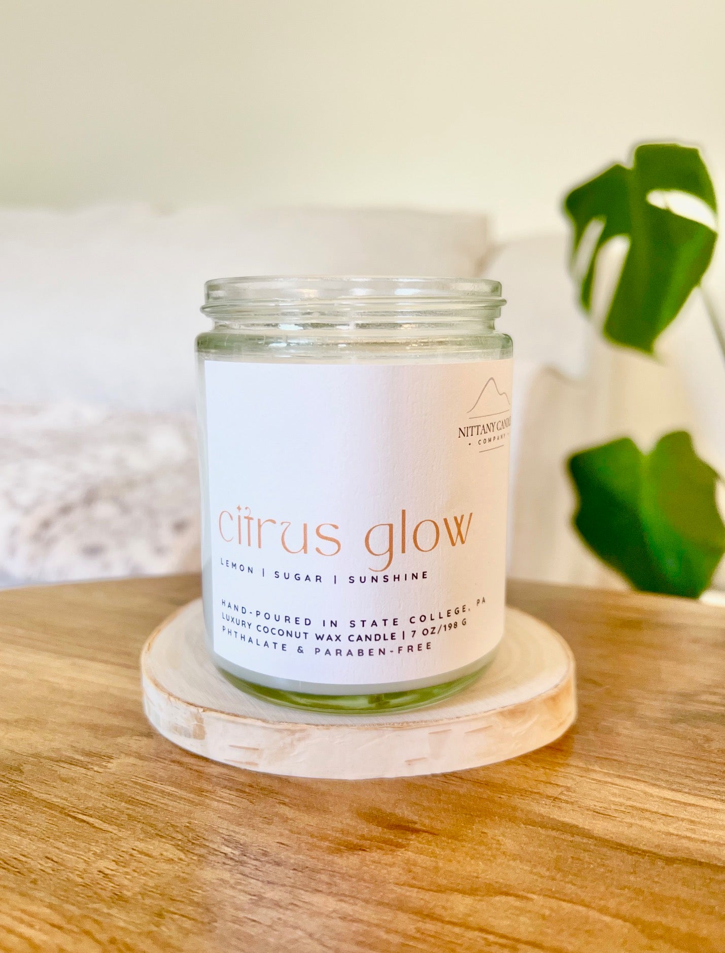 Nittany Candle Company candle labeled "Citrus Glow" in a clear jar