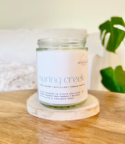 Clean-burning and nontoxic candle jar labeled 'Spring Creek'