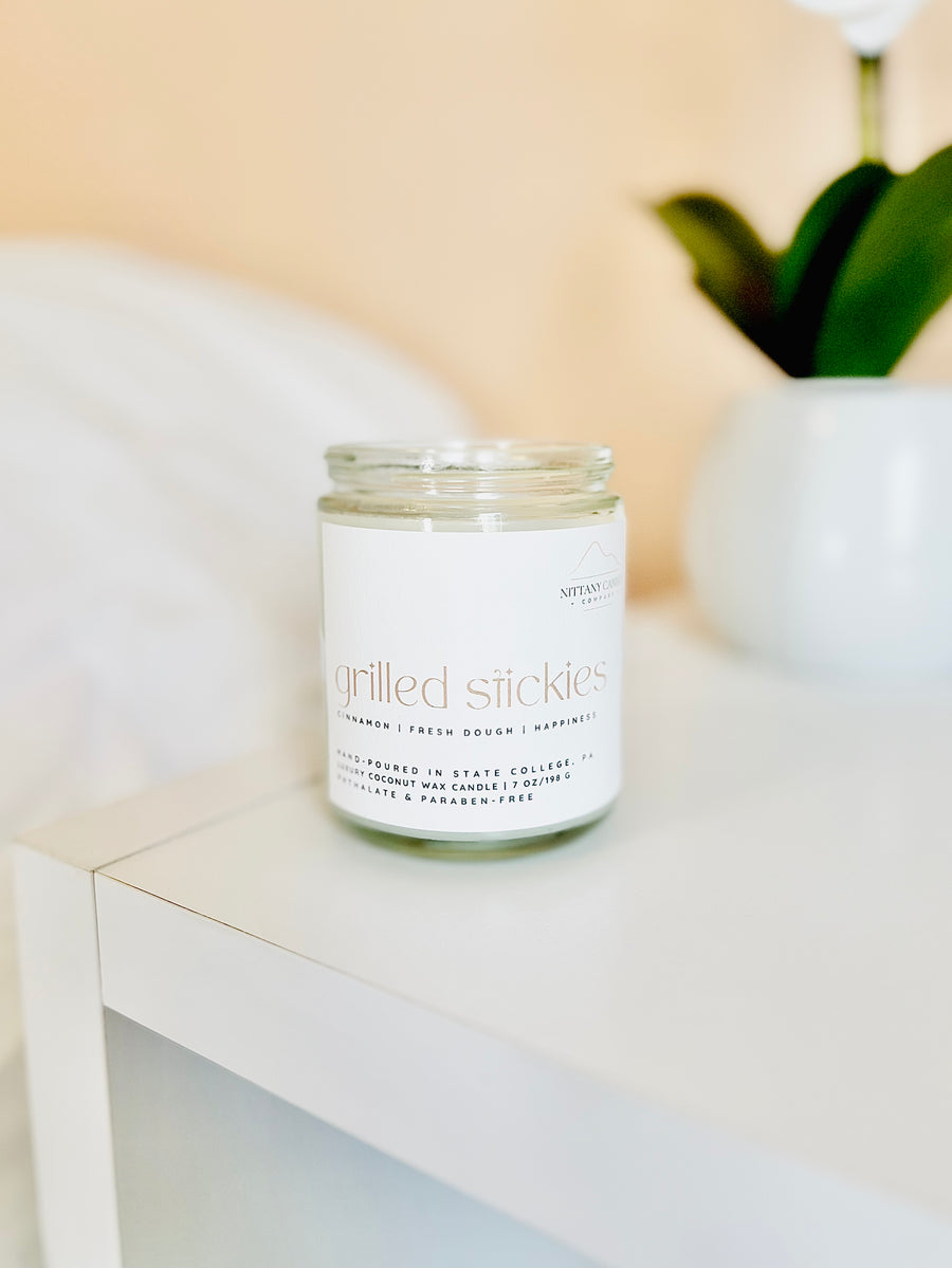A jar candle made by Nittany Candle Company that smells like cinnamon rolls