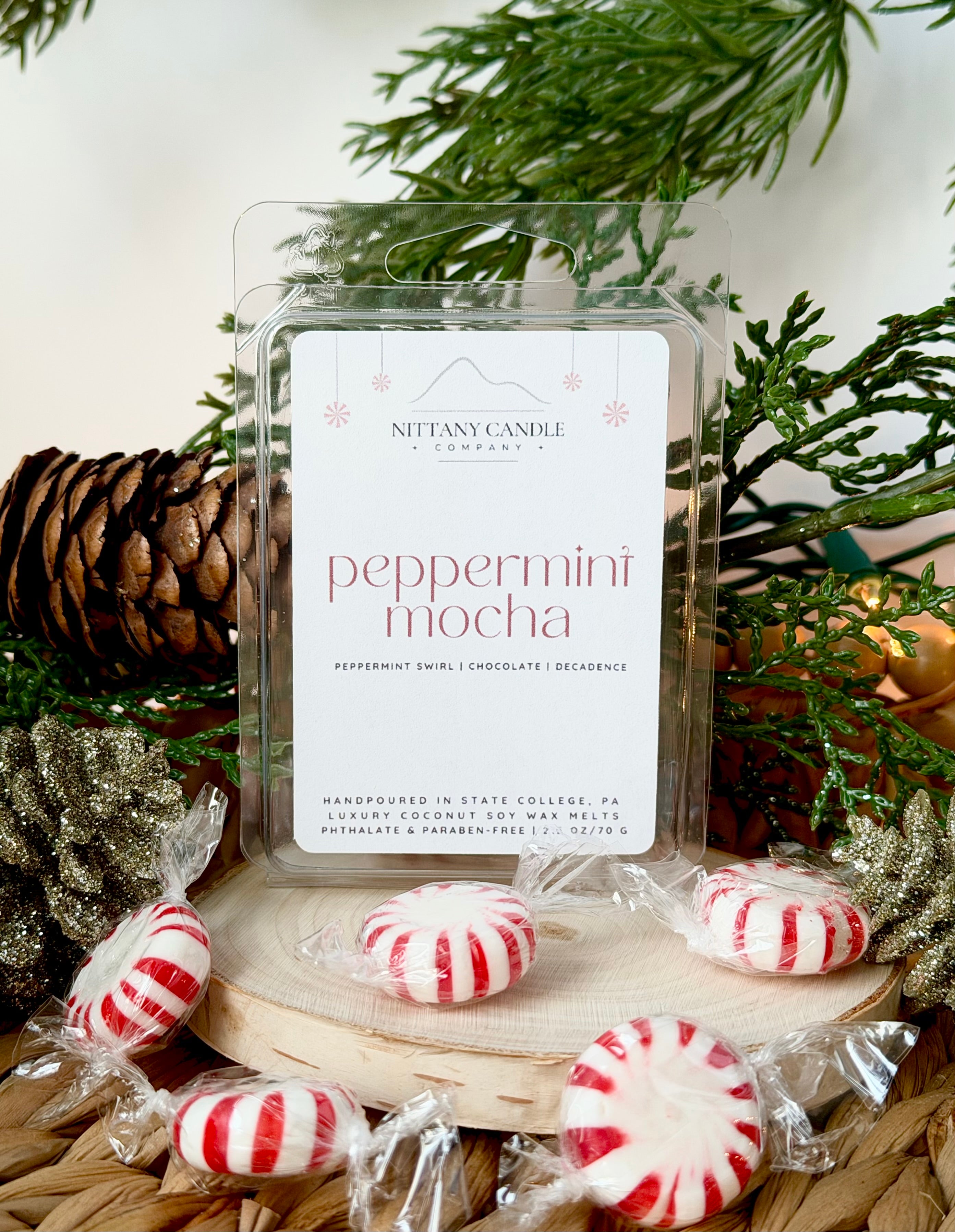 Nittany Candle Company peppermint mocha wax melts with peppermint candies and Christmas decor.
