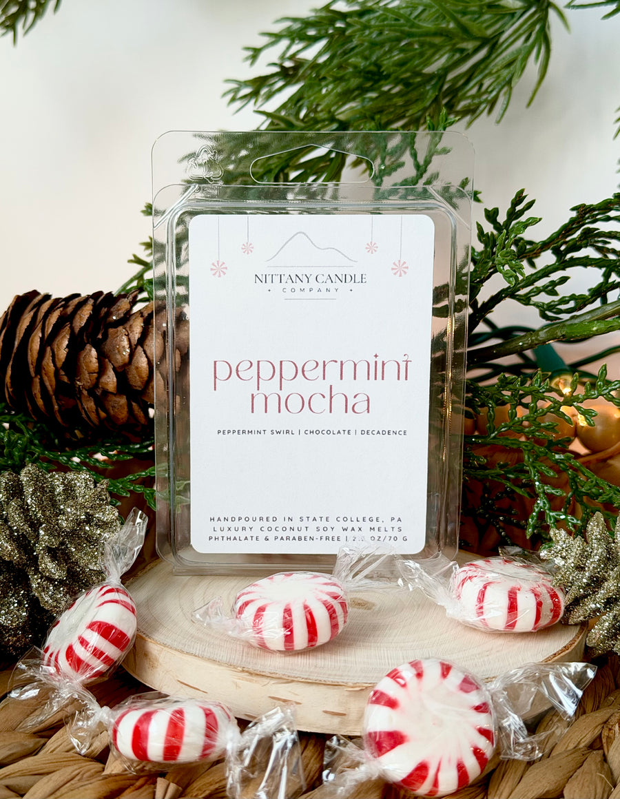 Nittany Candle Company peppermint mocha wax melts with peppermint candies and Christmas decor.