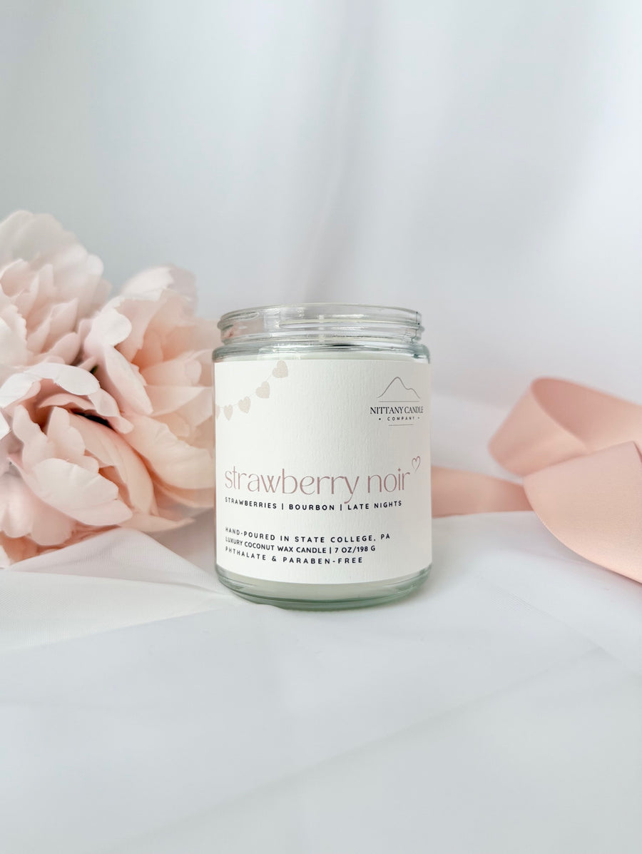 Nittany Candle Company candle labeled 'Strawberry Noir' with pink flowers and a white background