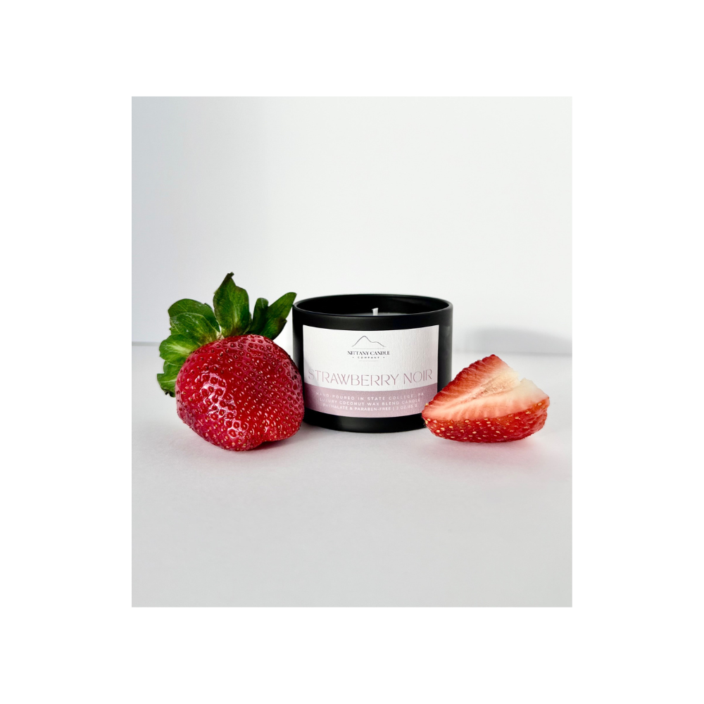 Strawberry scented candle with strawberries on a white background