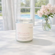 Candle labeled 'Valley Paradise' on a table with a scenic background