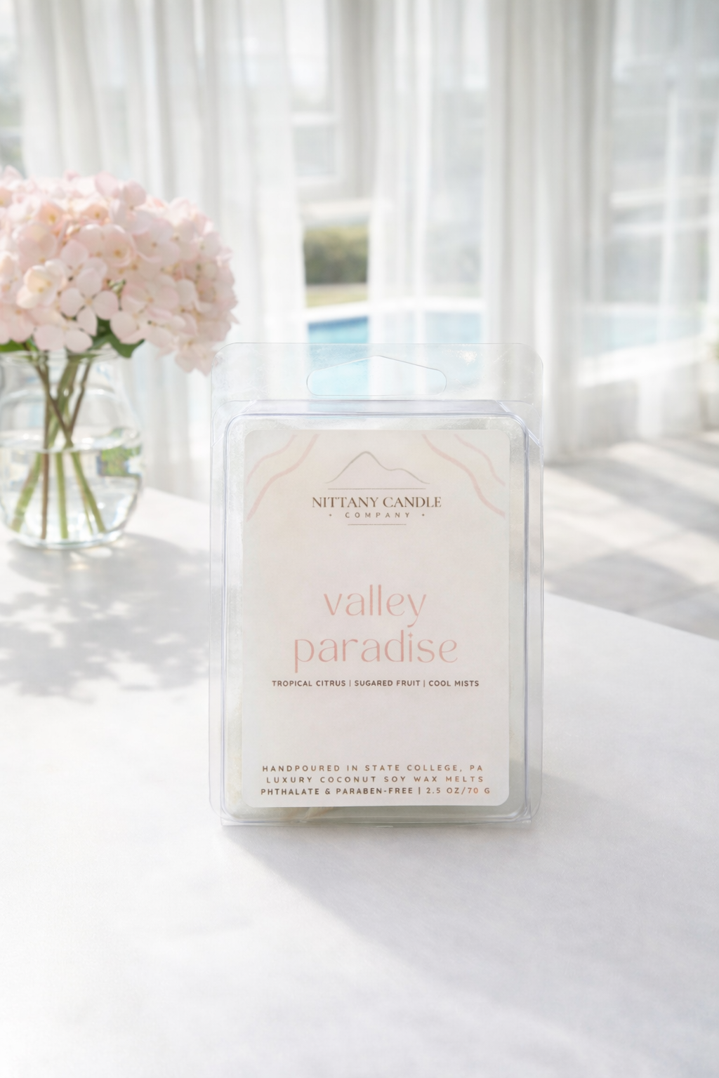 State College-themed wax melts titled Valley Paradise on a white table with flowy curtains and pink flowers in the background