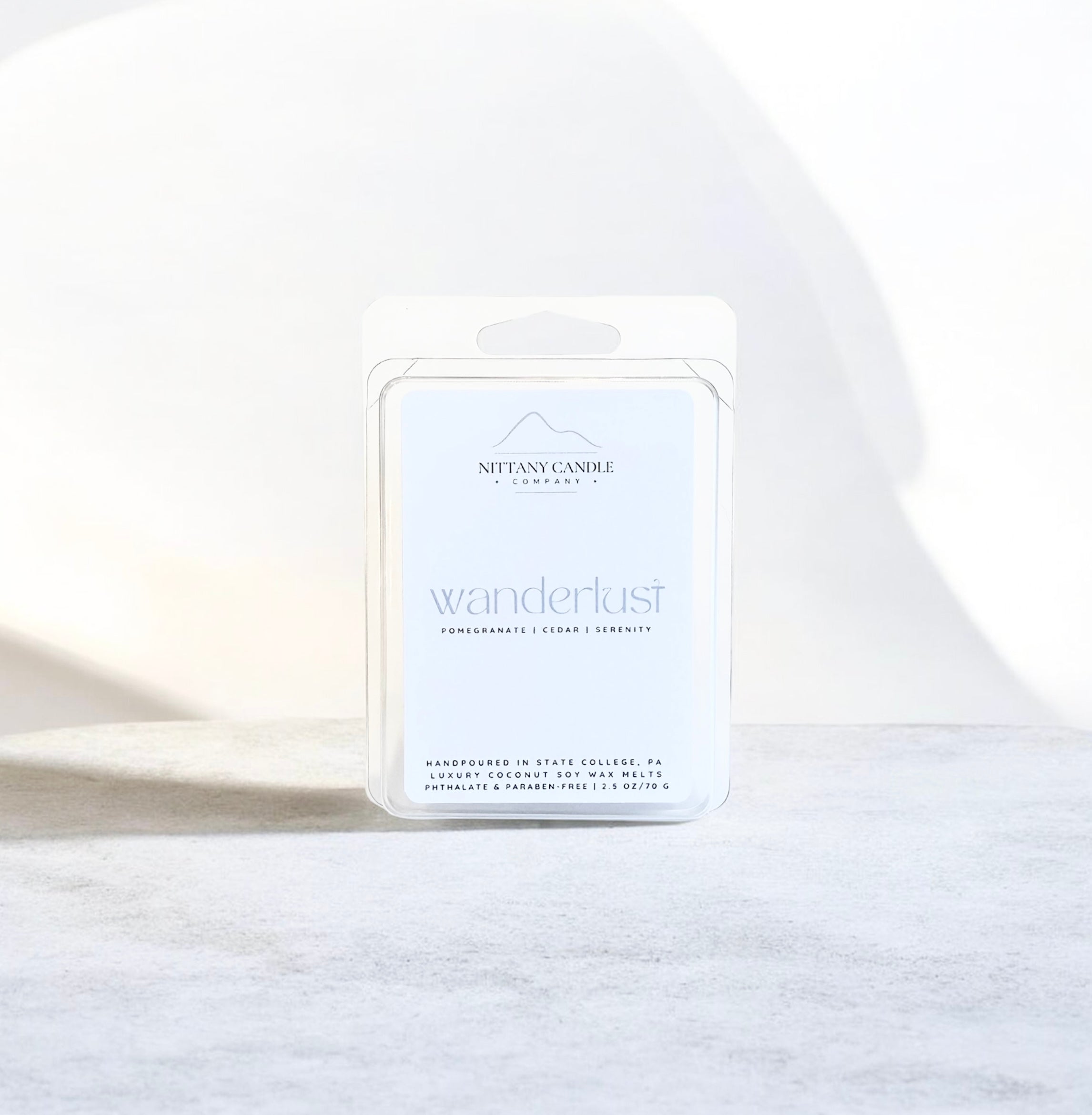 Nittany Candle Company 'wanderlust' candle packaging on a white background
