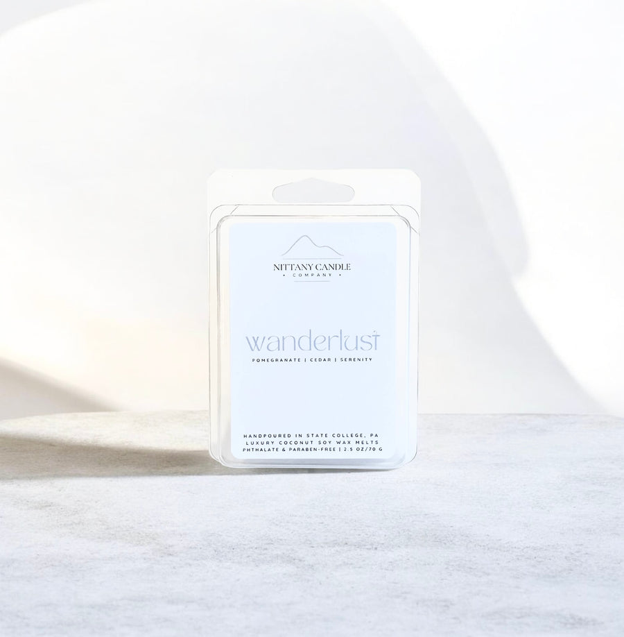 Nittany Candle Company 'wanderlust' candle packaging on a white background