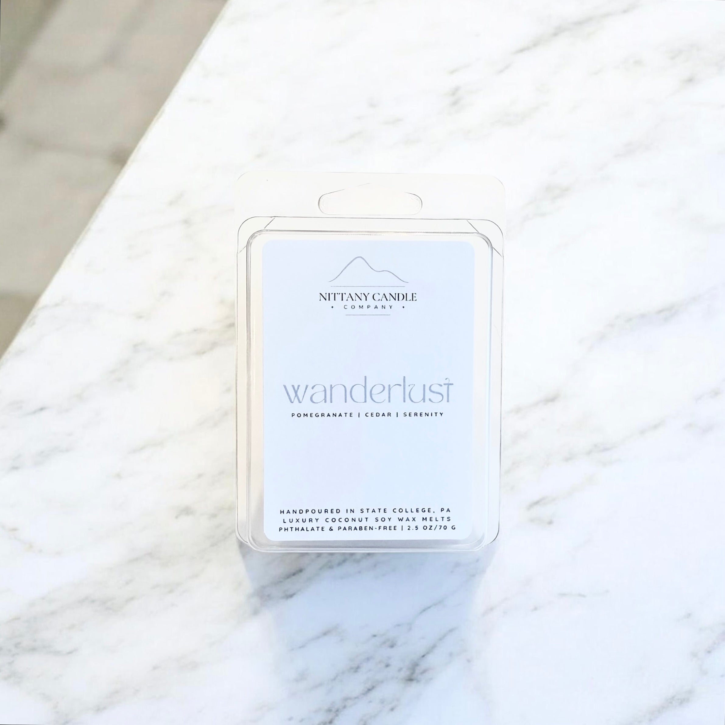 Nittany Candle Co. wax melt packaging on a marble surface