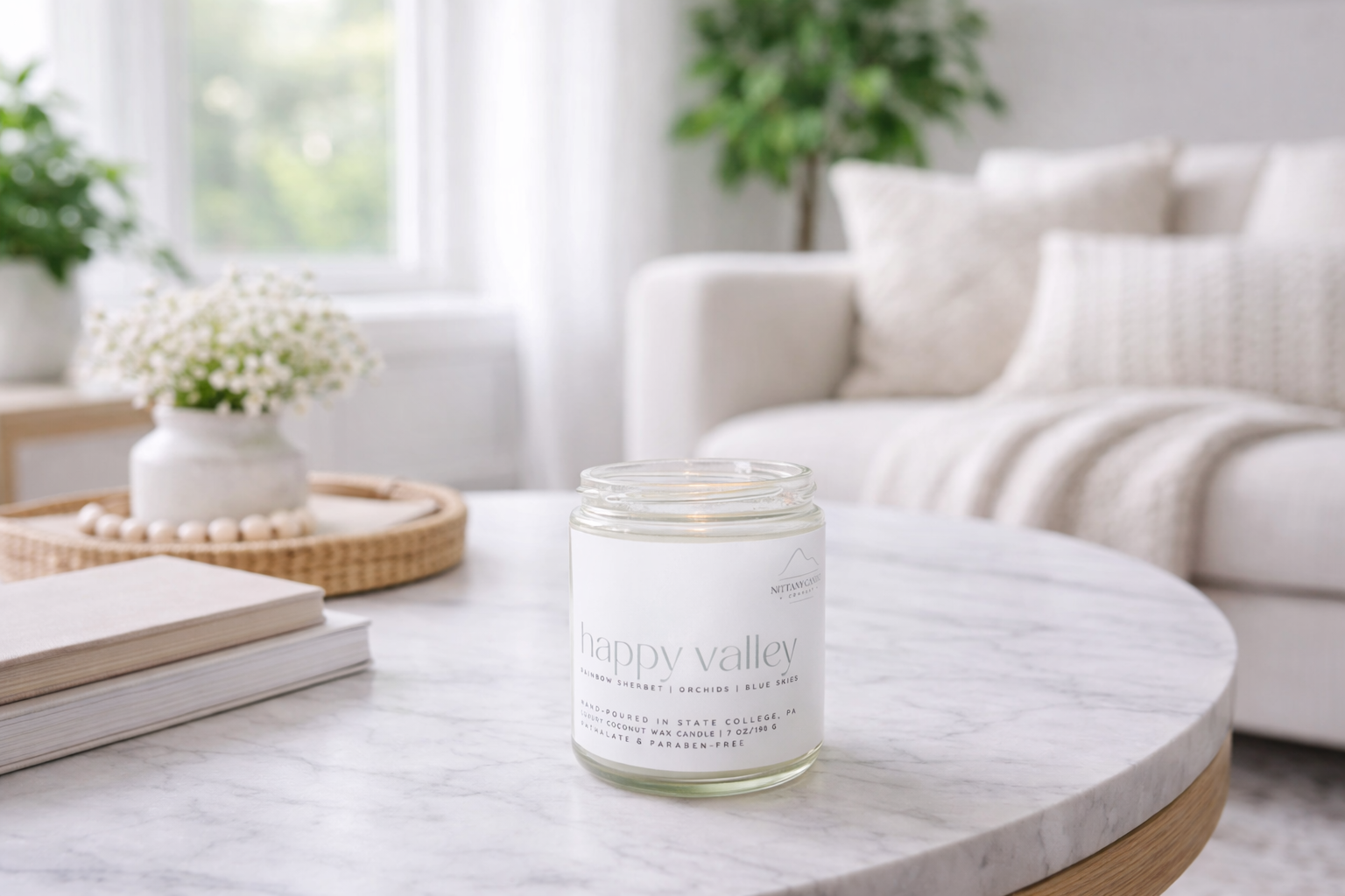 Candle labeled 'Happy Valley' on a marble table in a living room setting.
